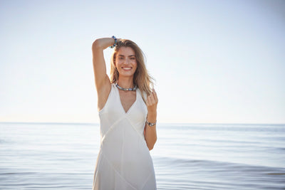 Model standing in a flower garden wearing Trollbeads jewellery