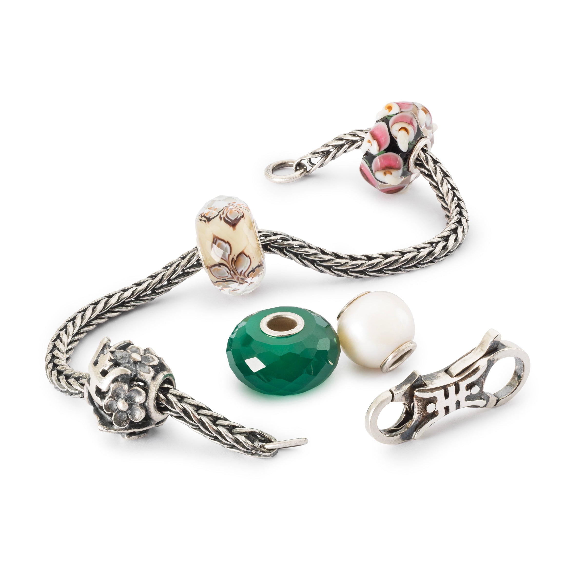 Trollbeads bracelet in glass, gemstone, pearl and silver is being assembled