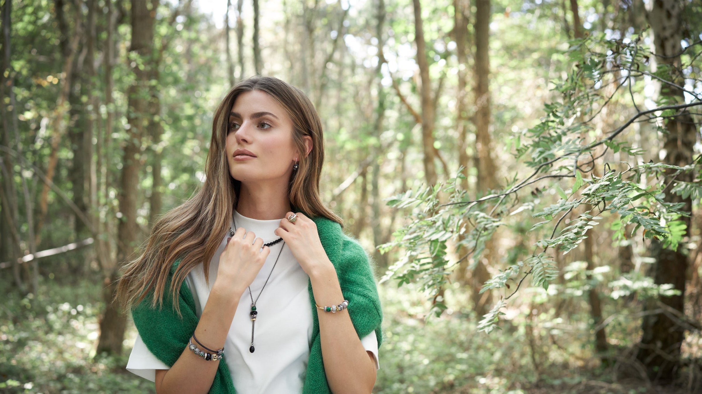 Model in forest with Trollbeads jewellery autumn collection